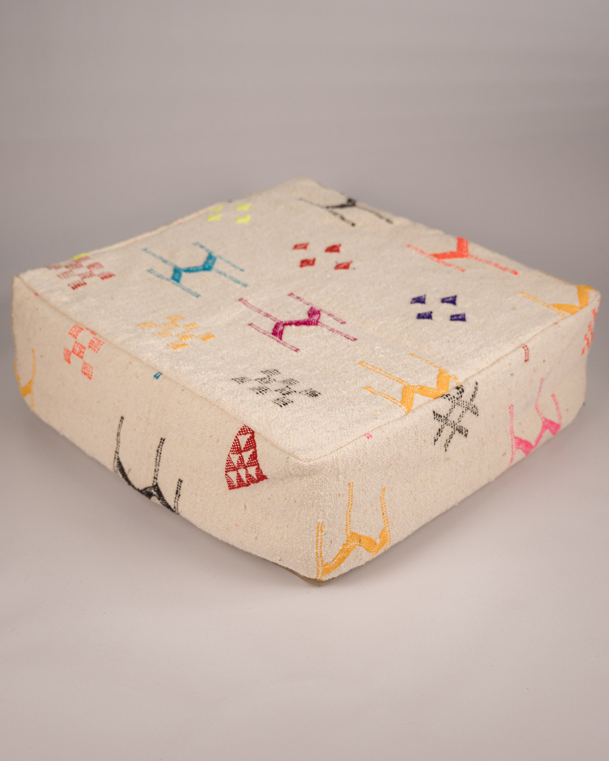 Handgemachter Boho-Pouf aus Schurwolle weiß gemustert